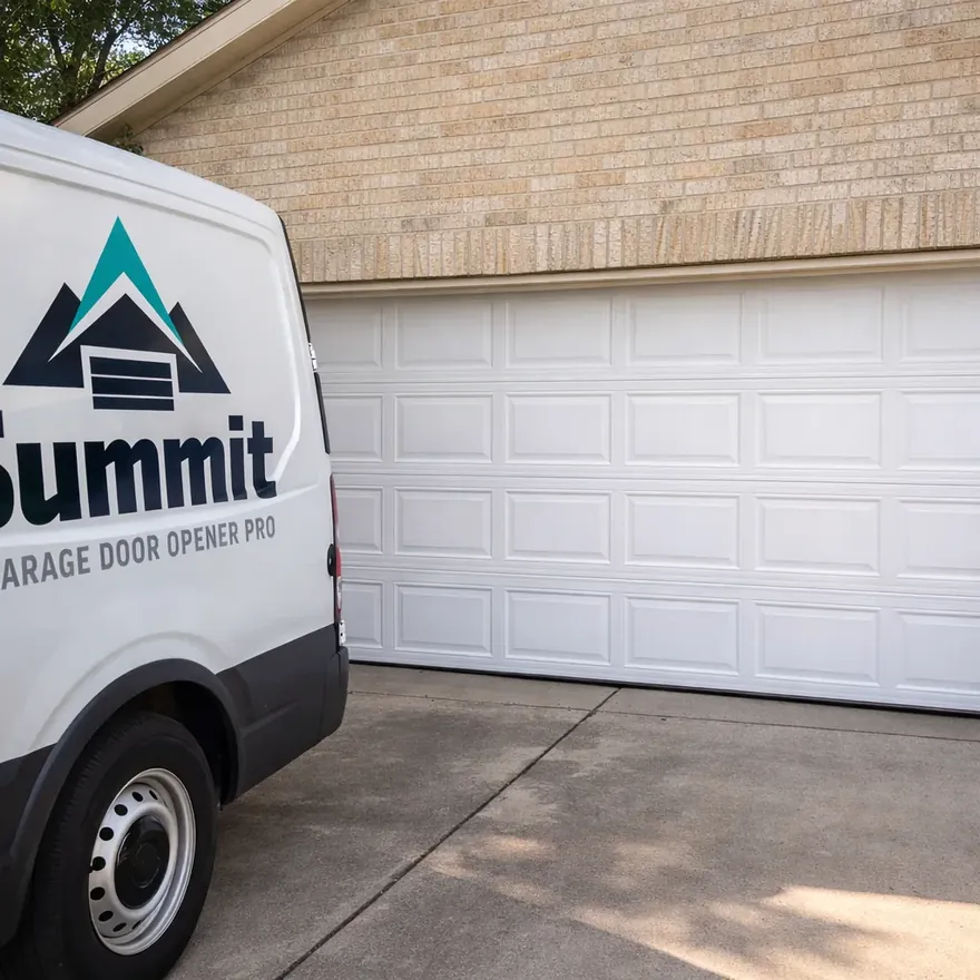 A finished residential garage door with a replaced middle panel, seams aligned so the new panel isn't visually obvious from the driveway.