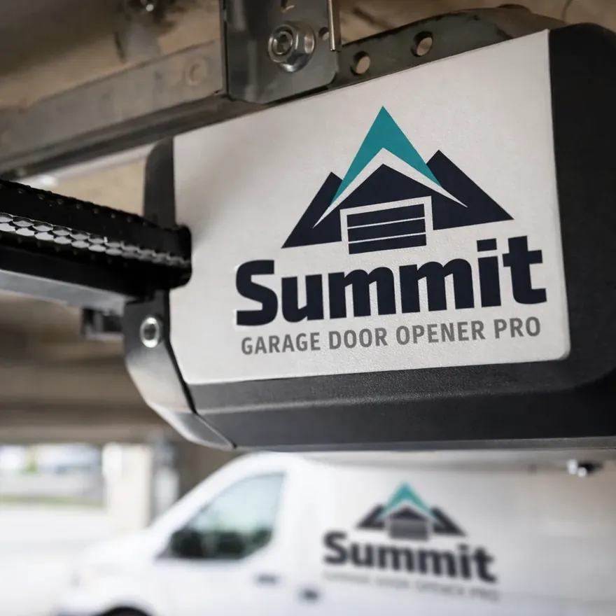 Close-up of a newly installed belt-drive garage door opener motor unit mounted on the ceiling track.